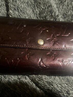 This is a  Louis Vuitton Monogram Vernis Portefeuille Sarah wallet.